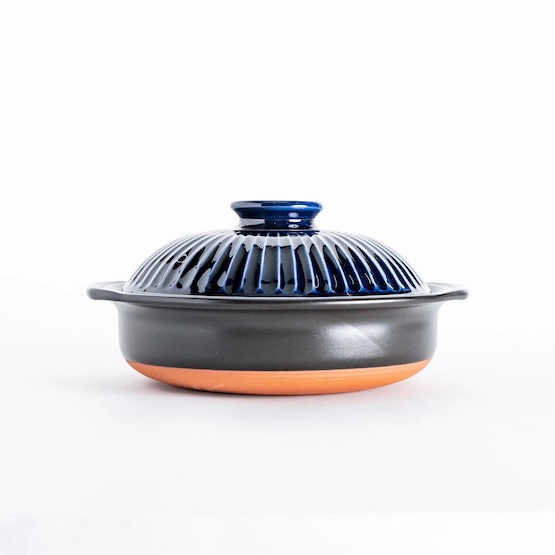 Blue and gray ceramic donabe with lid, traditional Japanese cookware, on white background.
