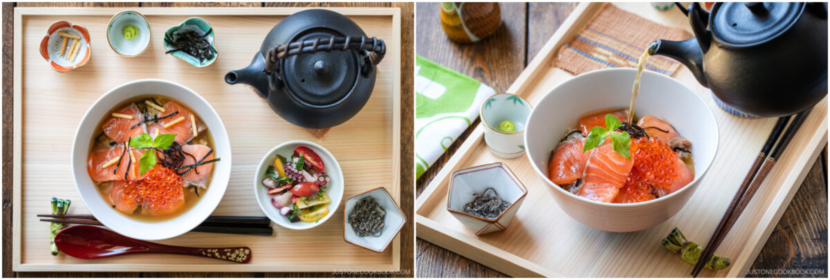 A wooden tray with a bowl of Japanese rice topped with salmon, salmon roe, and garnish, a side dish, chopsticks, and a teapot pouring broth into the bowl.
