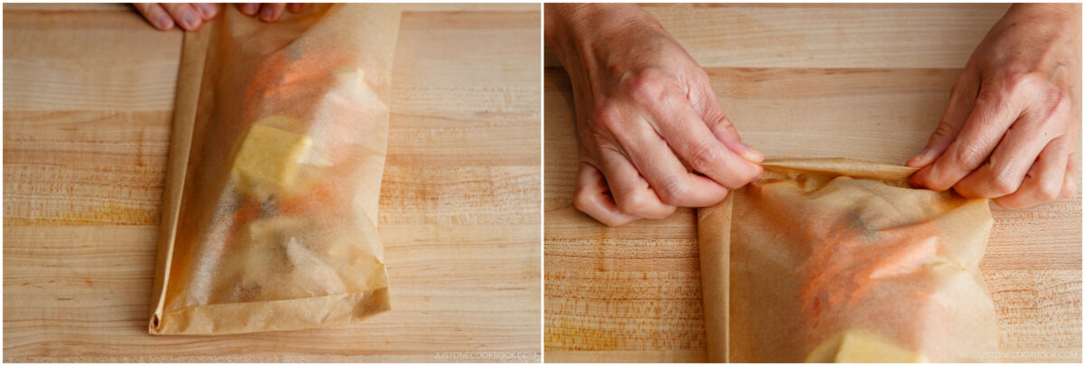 Two side-by-side images show hands folding parchment paper around seasoned food, preparing it for baking on a wooden surface. The food, including butter, is partially visible through the translucent paper.
