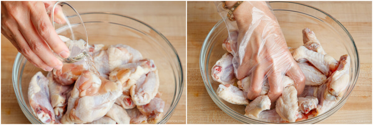 Two side-by-side images: On the left, liquid is being poured over raw chicken wings in a glass bowl. On the right, a gloved hand mixes the chicken wings in the bowl. Both are on a wooden surface.