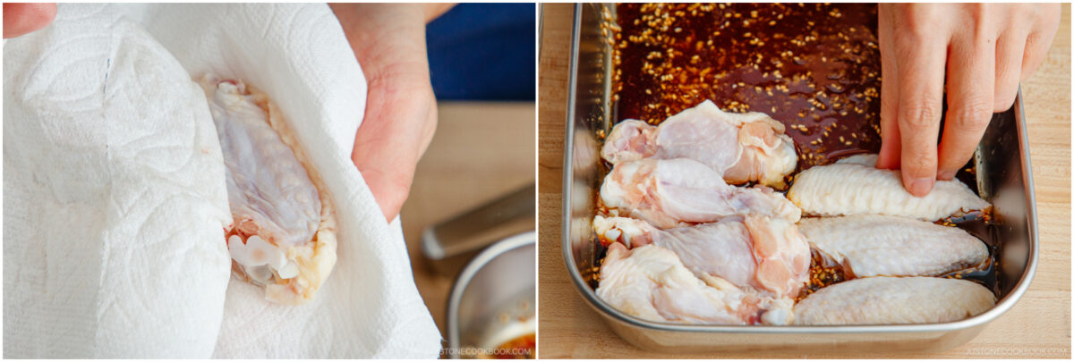 Close-up of hands preparing chicken wings: on the left, drying a raw wing with a paper towel; on the right, arranging wings in a metal tray with marinade.
