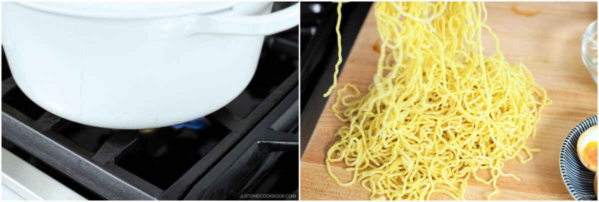A white pot is heating on a stovetop on the left; on the right, uncooked yellow ramen noodles are spread out on a wooden cutting board with a small bowl containing an egg yolk nearby.