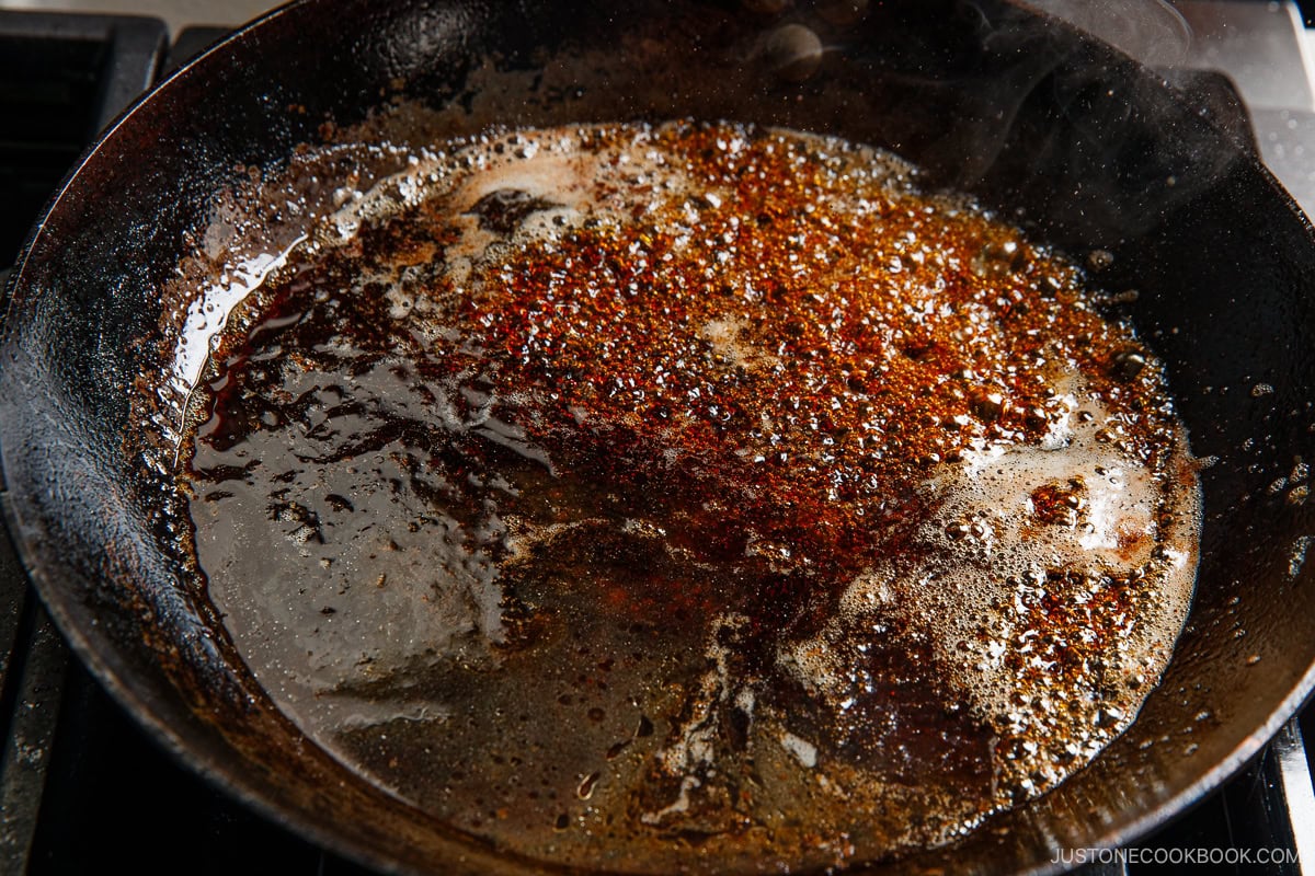 Adding the teriyaki sauce in the pan.
