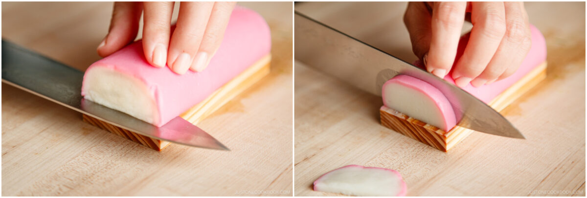 Close-up of hands slicing a pink and white cylindrical food item on a wooden cutting board with a large knife.