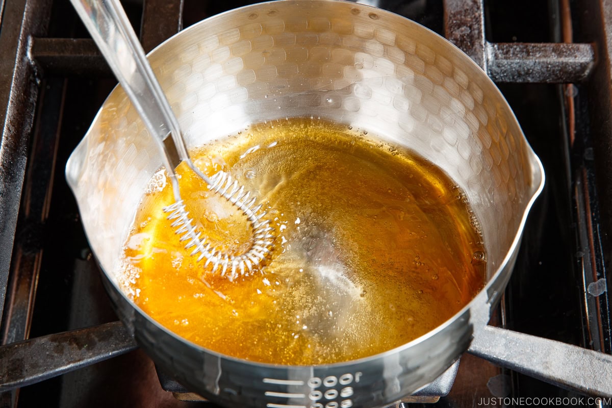 Mixing the seasonings in the saucepan.