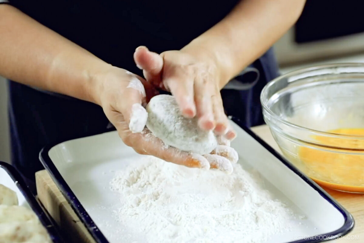 Dredge the patty in the flour.