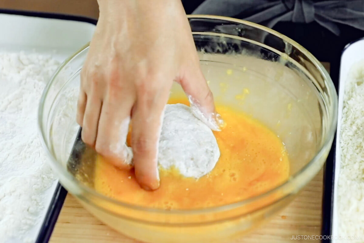 Dredge the patty in the eggs.