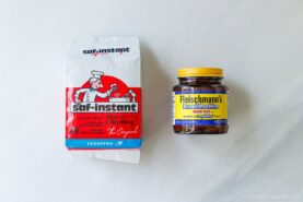 A package of Saf-Instant dry yeast and a jar of Fleischmann’s Bread Machine yeast sit side by side on a light-colored surface.