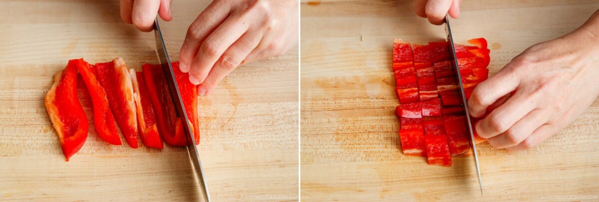 A person prepares ingredients for gapao rice by using a knife to slice a red bell pepper into strips on a wooden cutting board, then dicing the strips into small pieces.