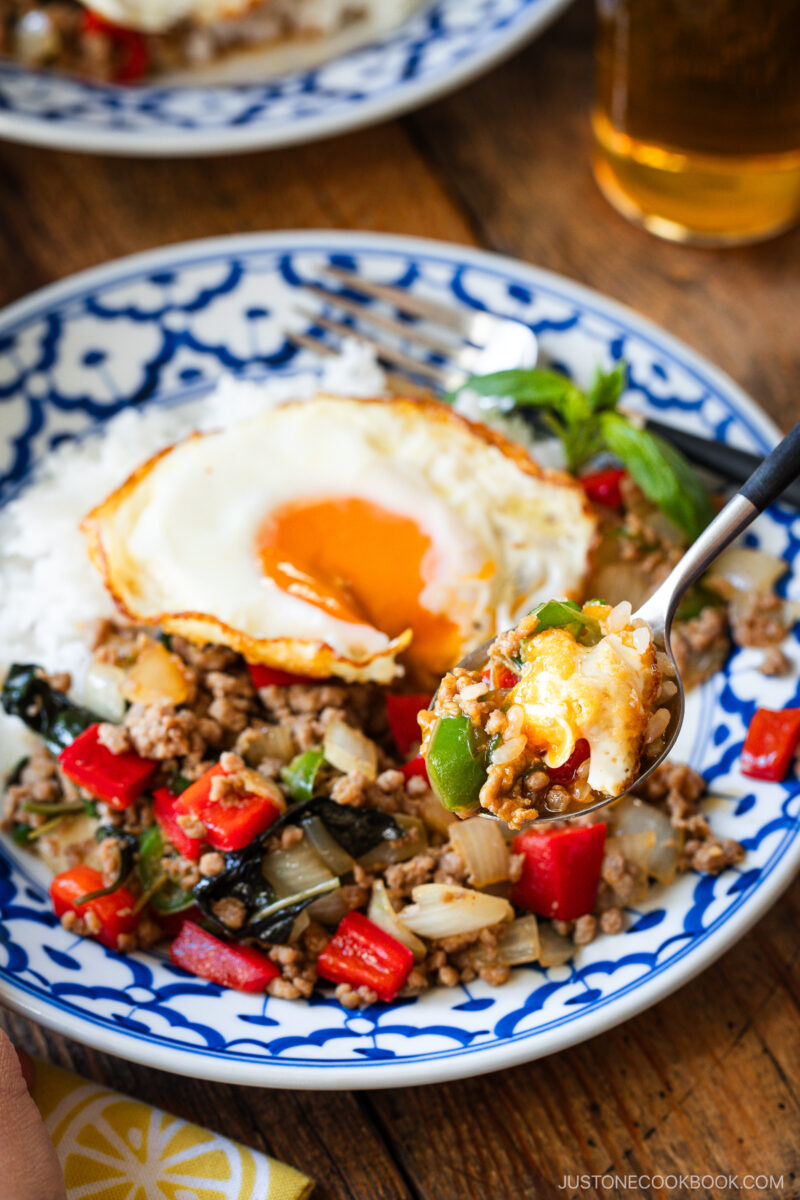 A plate of gapao rice with a spoon.